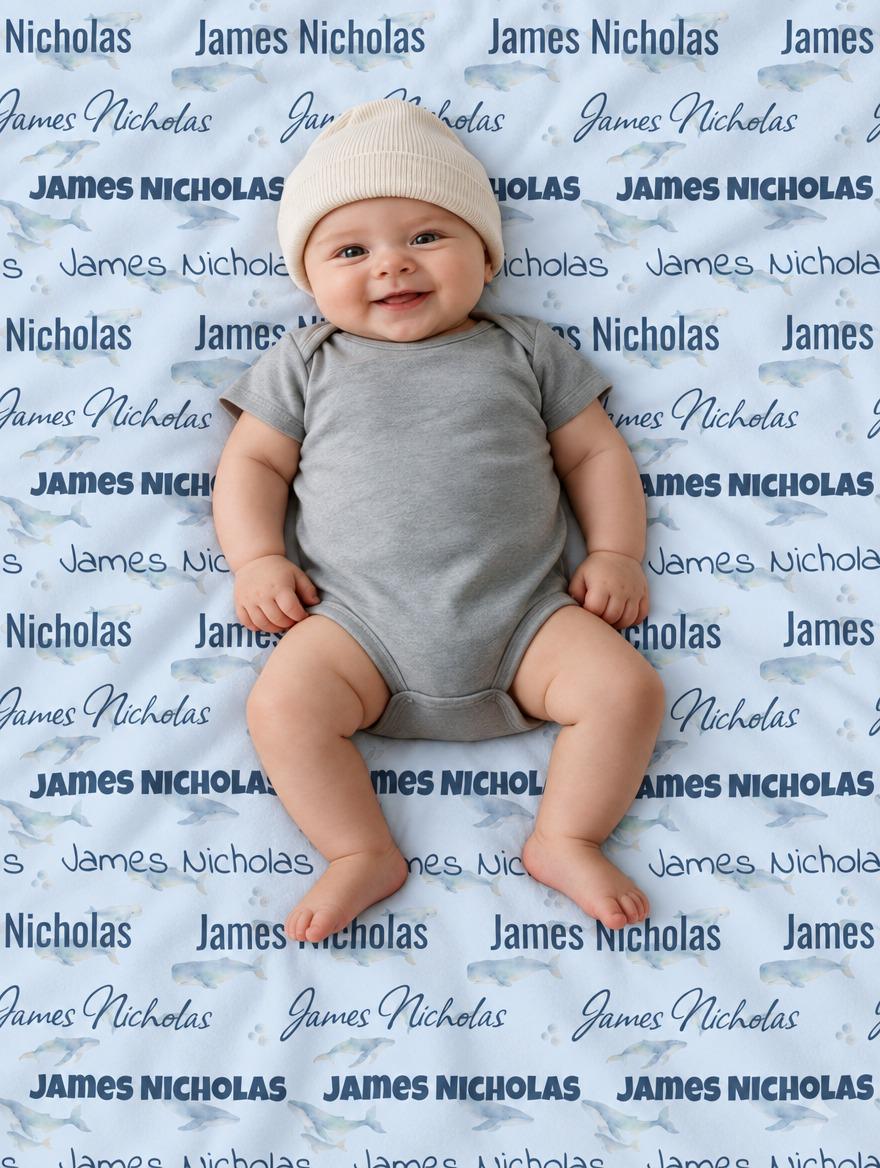 Personalized dusty blue whale baby blanket with repeating name