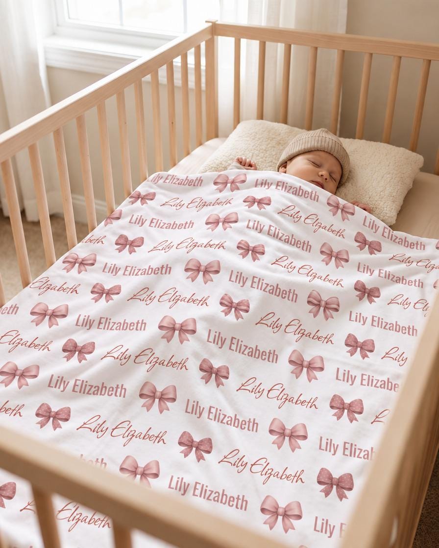 Personalized bow name blanket in wooden crib